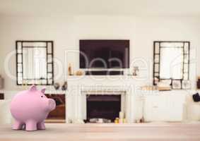 pink piggy bank against house living room (blurred)