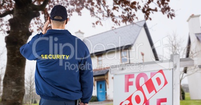 Rear view of security guard standing by sign board with text