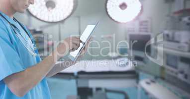 Doctor holding tablet in surgery operating theatre