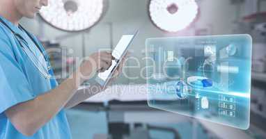 Doctor holding tablet with interface in surgery operating theatre