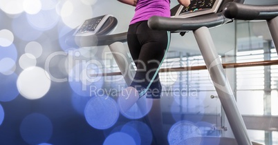 Midsection of woman running on treadmill