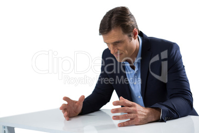 Frustrated businessman gesturing against white background