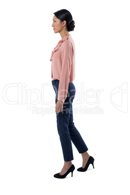 Female executive standing on white background