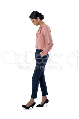 Female executive standing on white background
