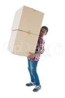 Boy carrying heavy boxes against white background