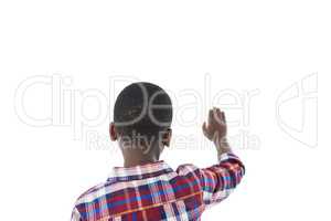 Boy pretending to touch an invisible screen against white background