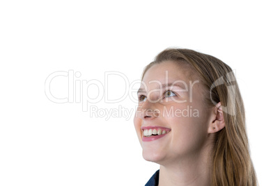 Thoughtful teenage girl smiling against white background