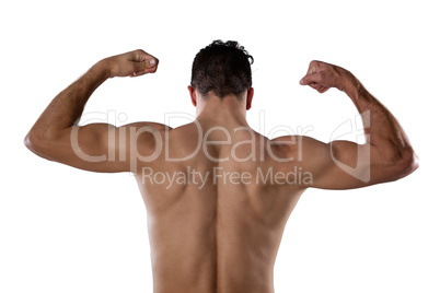 Rear view of sports person flexing muscles