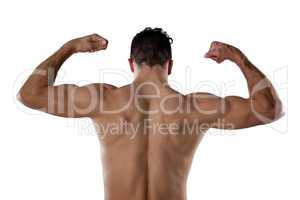 Rear view of sports person flexing muscles
