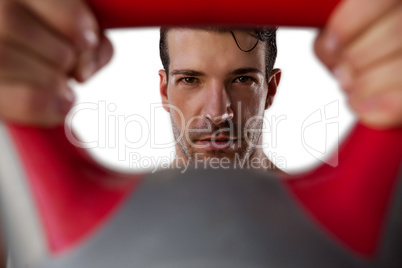 Portrait of sportsman exercising with kettle bell