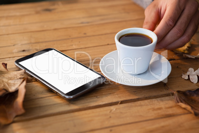 Hand on man having a cup of black coffee