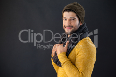 Smiling man posing against black background