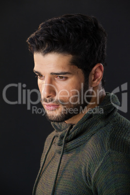 Man standing against black background