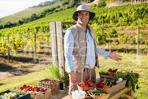 Portrait of happy man standing at vegetable stall