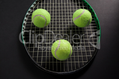 High angle view of balls on tennis racket