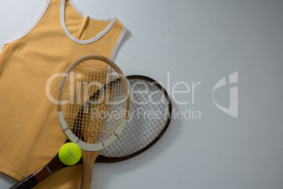 Directly above shot of rackets with vest and tennis ball