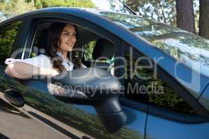 Smiling woman driving a car