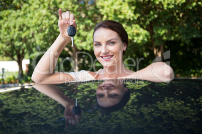 Beautiful woman holding a car key