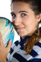 Close up portrait of female athlete holding rugby ball