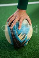 Close up of hand holding rugby ball