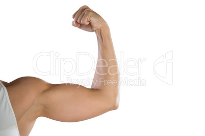 Cropped image of sportswoman flexing muscles