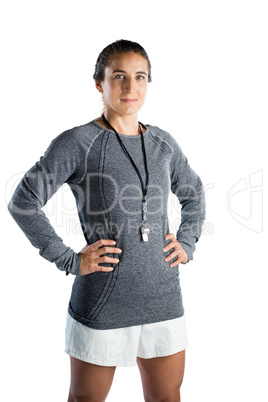 Portrait of smiling female coach with hands on hip