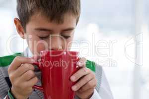 Boy as business executive drinking coffee