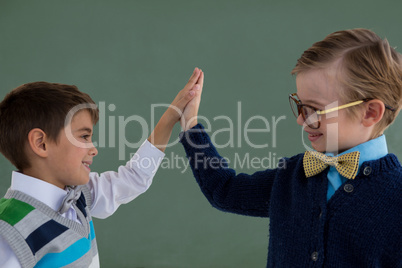 Kids as business executive giving high five to each other