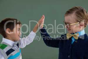 Kids as business executive giving high five to each other