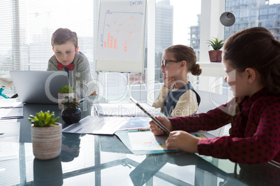 Kids as business executives interacting while meeting