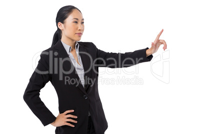 Businesswoman pressing an invisible virtual screen