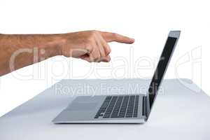 Male executive pointing at laptop