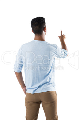 Man pretending to touch an invisible screen against white background