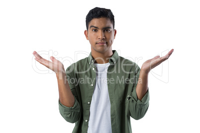 Frowning man gesturing against white background