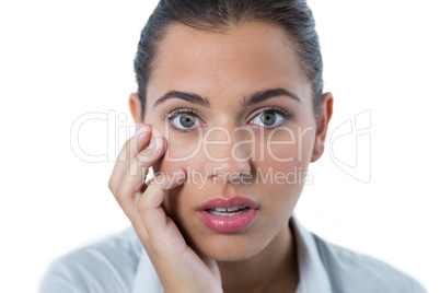 Surprised female executive standing against white background