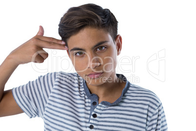 Teenage boy making gun gesture with his hand