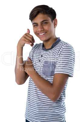 Teenage boy pretending to talk on a cell phone