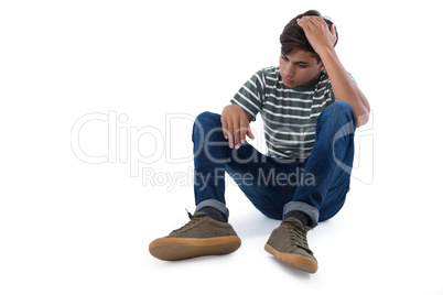 Teenage boy relaxing against white background