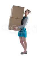 Teenager girl carrying heavy boxes