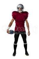 Full length of determined American football player wearing helmet