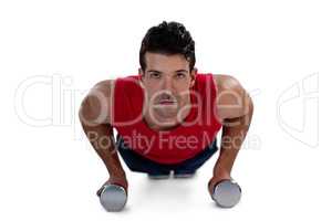 Portrait of determined sports player exercising with dumbbells