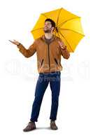 Smiling man standing under umbrella