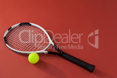 High angle view of tennis racket and fluorescent yellow ball