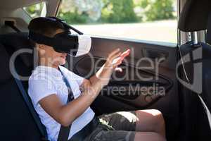 Teenage boy using virtual reality headset in the car
