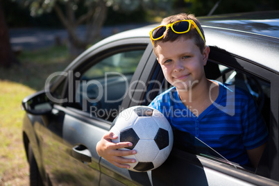 Teenage boy looking from open car window