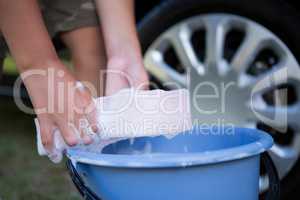 Teenage boy washing a car