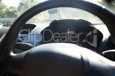 Car interior with steering wheel and dashboard