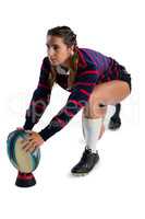 Female athlete keeping rugby ball on tee