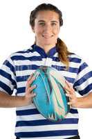 Portrait of smiling female player holding rugby ball