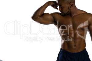 Shirtless sportsman flexing muscles